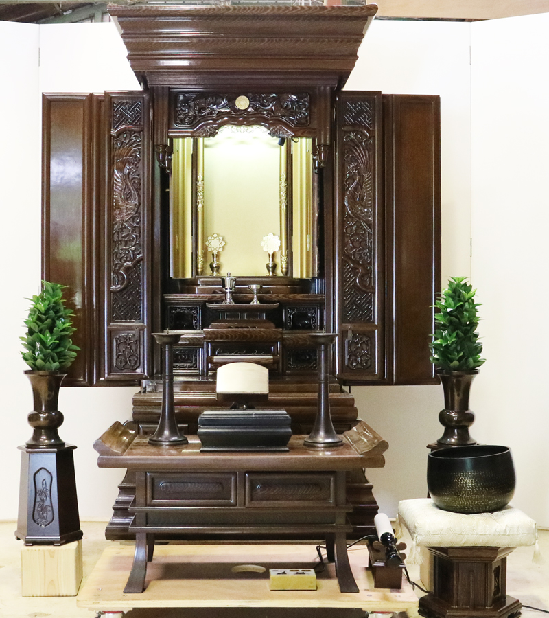 創価学会仏壇専門店桜梅桃李.comより発売いたします、会場拠点用鉄刀木　伝統型押込み扉仏壇KB004です。  経机・花台・リン台付きで、本格的なお仏壇となります。 製品名 	  創価学会中古仏壇　KB004 設置 	和室・洋室・拠点・男子部拠点にも最適です 種別 	厨子型電動仏壇 サイズ 	   仏壇本体　高さ:約173cm ×幅:約91cm×奥行:約74cm  扉最大の幅:約48cm  厨子内　高さ:約60cm×幅:約37cm  経机　高さ:約41cm×幅:約78cm×奥行:約41cm 	  材質 	鉄刀木・貼り・無垢・MDF 機能 	  スイッチ式電動扉  経机引き出し2箇所・仏壇本体引き出し4か所　計6箇所  掲載仏具一式付き(造花しきみ二本・仏器茶器のみ新品)  厨子背板を、新品の金吹きの塗装板に替えました。