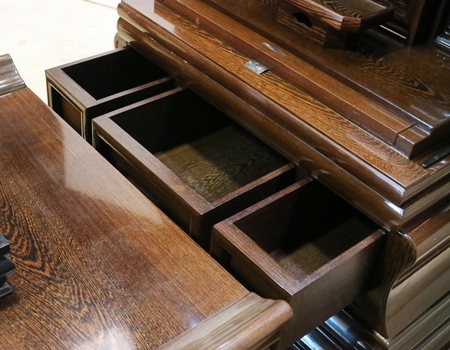 創価学会仏壇専門店桜梅桃李.comより発売いたします、会場拠点用鉄刀木　伝統型押込み扉仏壇KB004です。  経机・花台・リン台付きで、本格的なお仏壇となります。 製品名 	  創価学会中古仏壇　KB004 設置 	和室・洋室・拠点・男子部拠点にも最適です 種別 	厨子型電動仏壇 サイズ 	   仏壇本体　高さ:約173cm ×幅:約91cm×奥行:約74cm  扉最大の幅:約48cm  厨子内　高さ:約60cm×幅:約37cm  経机　高さ:約41cm×幅:約78cm×奥行:約41cm 	  材質 	鉄刀木・貼り・無垢・MDF 機能 	  スイッチ式電動扉  経机引き出し2箇所・仏壇本体引き出し4か所　計6箇所  掲載仏具一式付き(造花しきみ二本・仏器茶器のみ新品)  厨子背板を、新品の金吹きの塗装板に替えました。